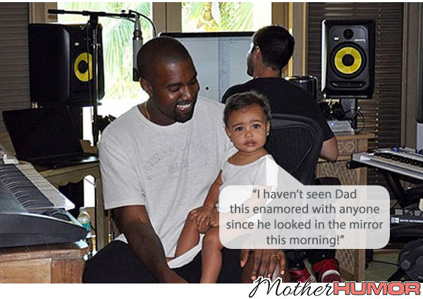 Picture of Kanye West smiling with North West on lap